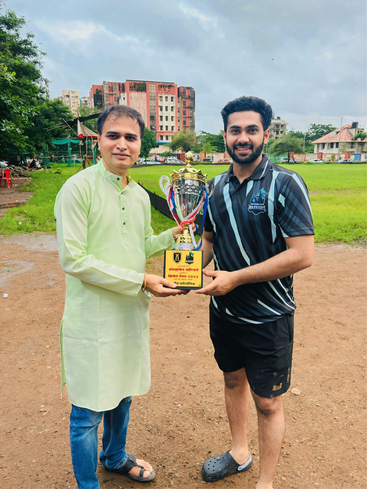 **Advocate Chinmay Chorghe with Senior Advocate Suhas Vekhande, celebrating a winning moment at an Advocates’ Sports Cricket Match.**